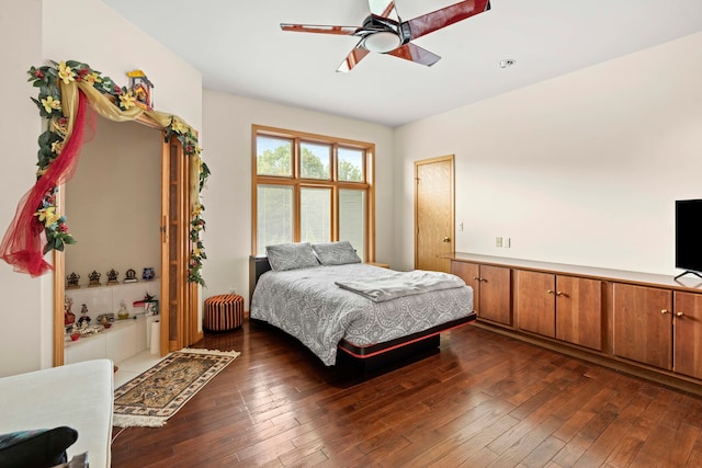 bedroom with ceiling fan and dark wood-type flooring