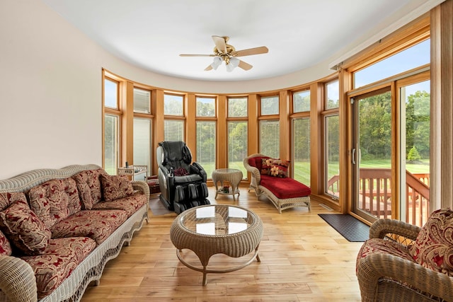 living room featuring light hardwood / wood-style flooring and ceiling fan