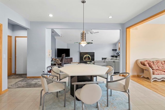 dining room with ceiling fan and light hardwood / wood-style flooring