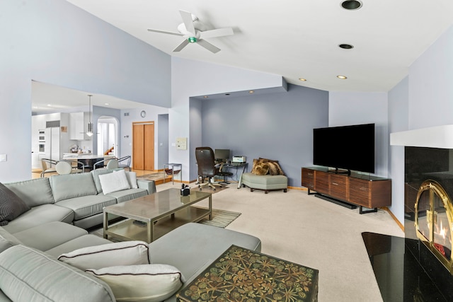 living room featuring light carpet, ceiling fan, and high vaulted ceiling