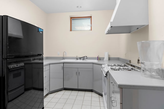 kitchen featuring gray cabinets, sink, stove, exhaust hood, and double oven