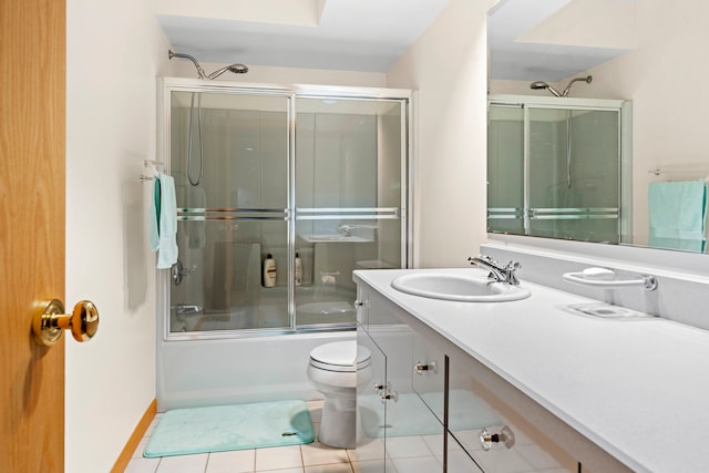 full bathroom with shower / bath combination with glass door, toilet, vanity, and tile patterned floors