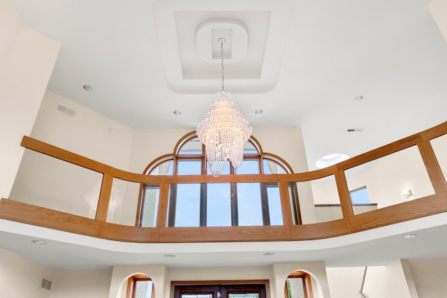 room details with an inviting chandelier and a tray ceiling