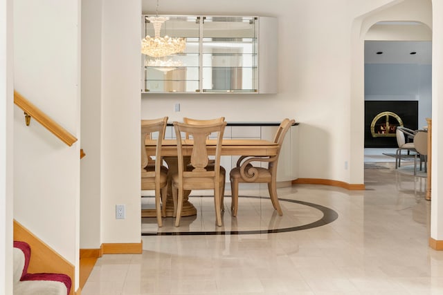 tiled dining area with a notable chandelier