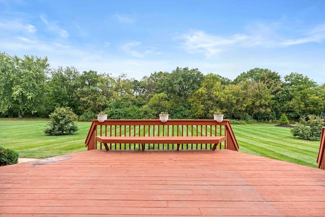 wooden terrace featuring a yard