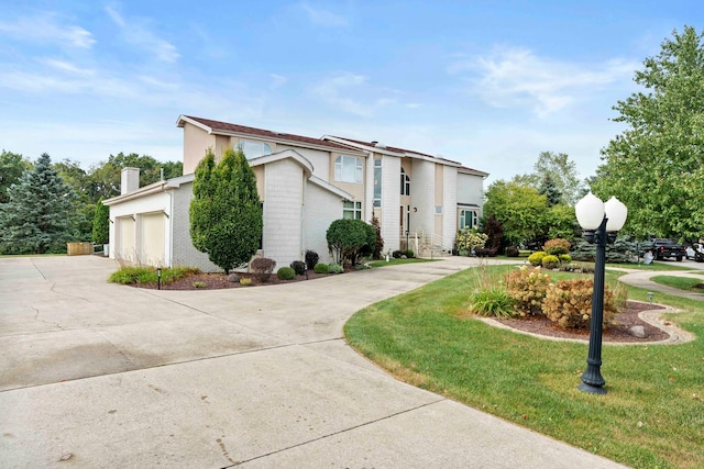 view of front of home with a garage and a front lawn