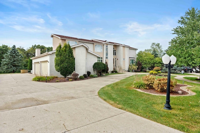 view of front of property with a garage and a front yard