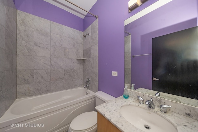 full bathroom with tiled shower / bath, vanity, and toilet