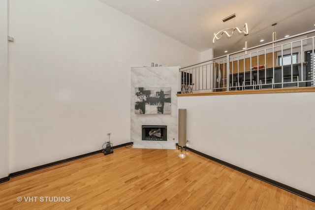 unfurnished living room with hardwood / wood-style floors and a premium fireplace