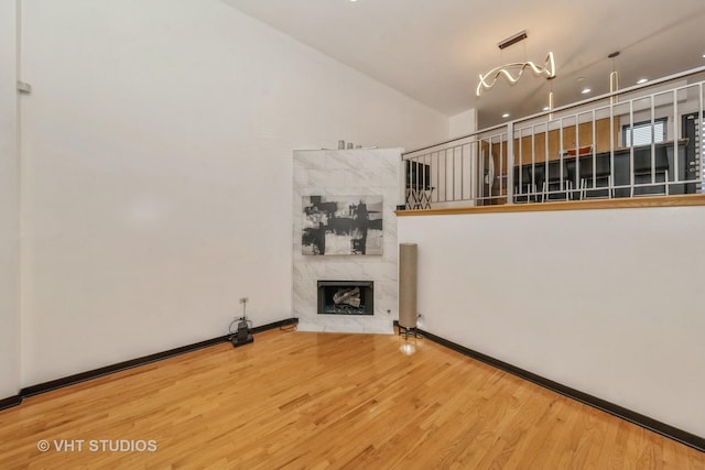 834 E 45th St, Chicago, IL 60653 - unfurnished living room featuring wood finished floors, a premium fireplace, recessed lighting, and a high ceiling