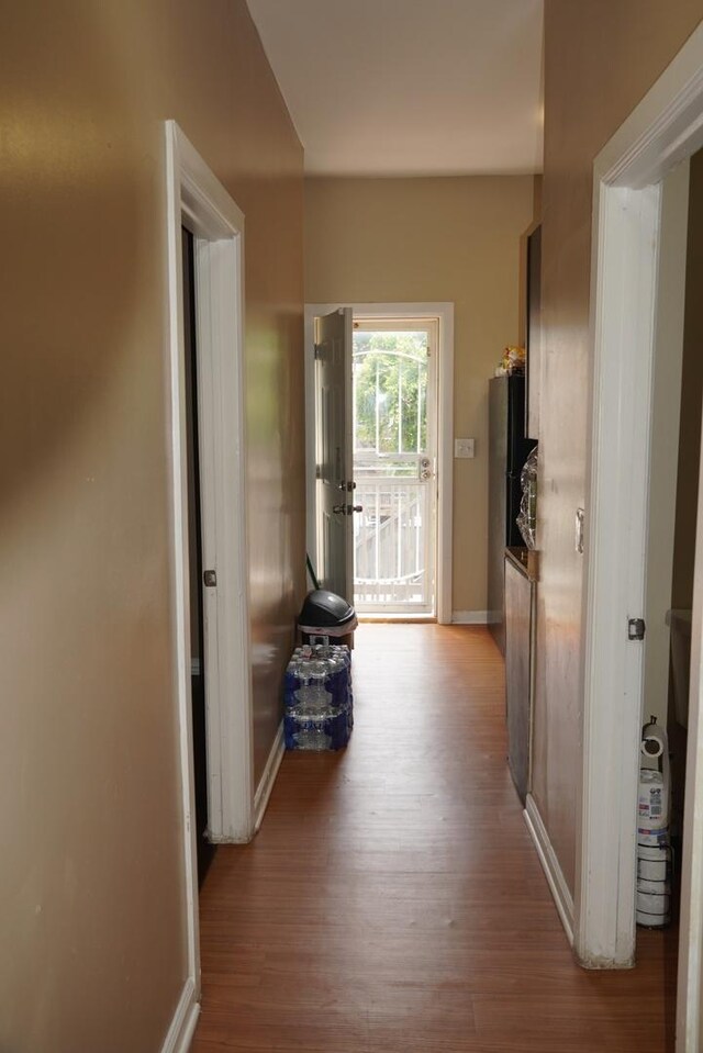 hallway with hardwood / wood-style flooring