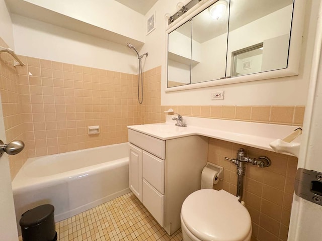 full bathroom with tiled shower / bath combo, vanity, toilet, and tile flooring