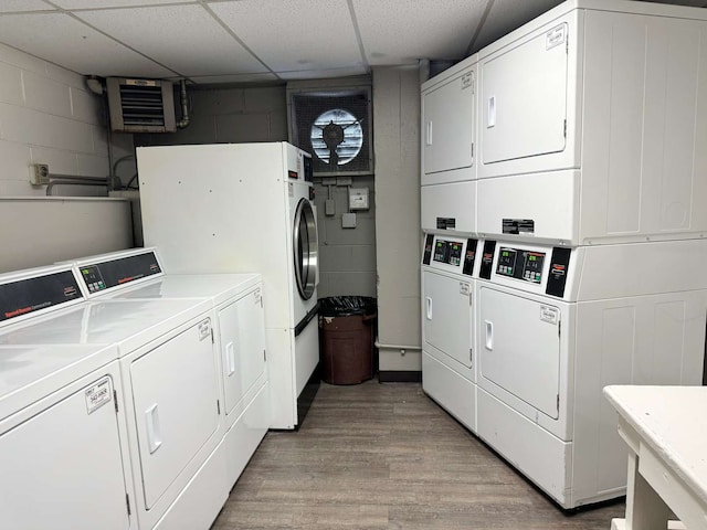 laundry area featuring light hardwood / wood-style flooring, stacked washer and clothes dryer, and washing machine and clothes dryer