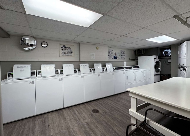 washroom featuring dark hardwood / wood-style flooring, washing machine and dryer, and stacked washer / drying machine