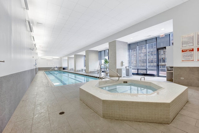 view of swimming pool with an indoor hot tub