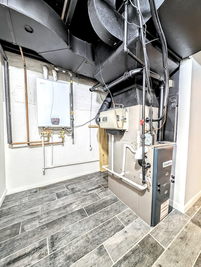 basement with wood-type flooring and tankless water heater