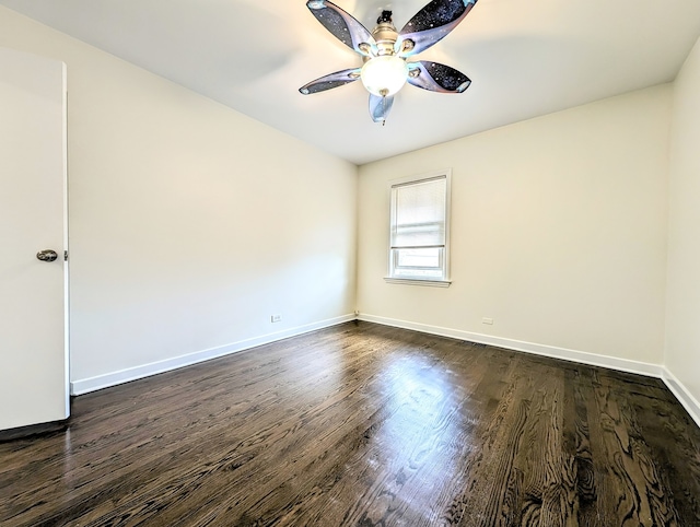 empty room featuring ceiling fan and dark hardwood / wood-style floors