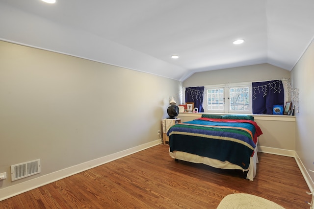 bedroom featuring wood-type flooring and vaulted ceiling