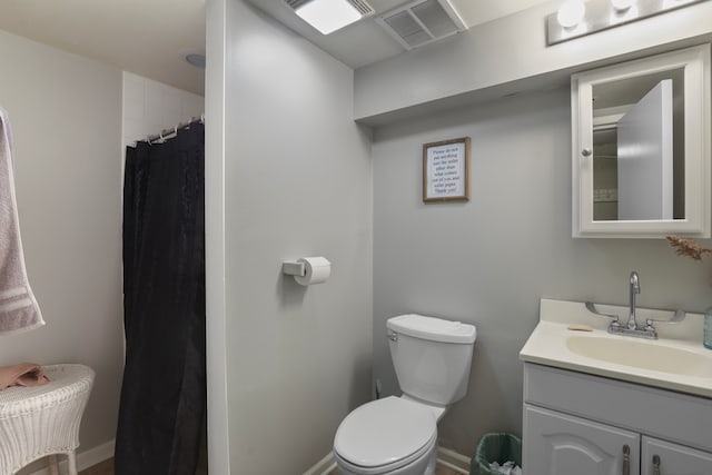 bathroom with vanity with extensive cabinet space and toilet