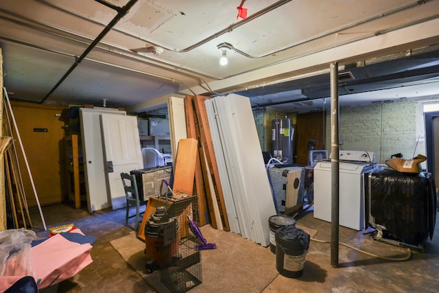 basement featuring water heater and washing machine and clothes dryer