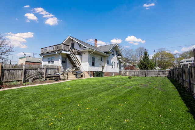 rear view of property with a yard