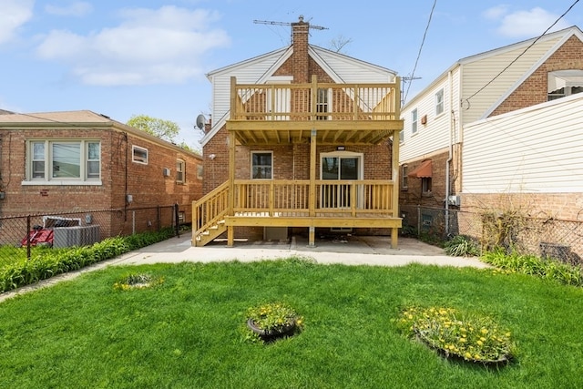 rear view of house with a balcony and a yard