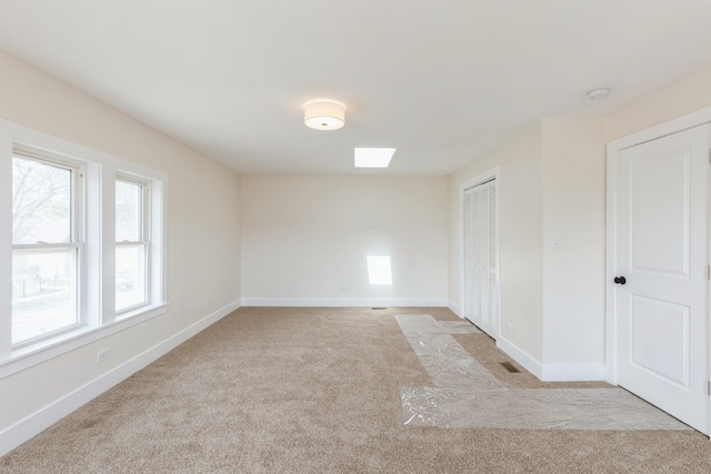 unfurnished room with light colored carpet