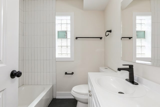 full bathroom featuring vanity, tile floors, toilet, and tiled shower / bath