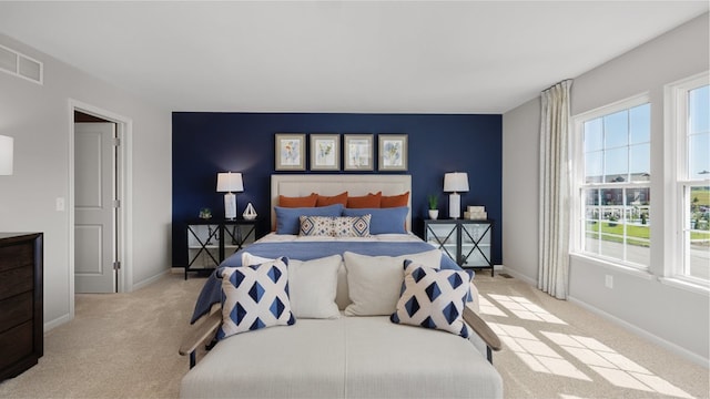 bedroom featuring light colored carpet