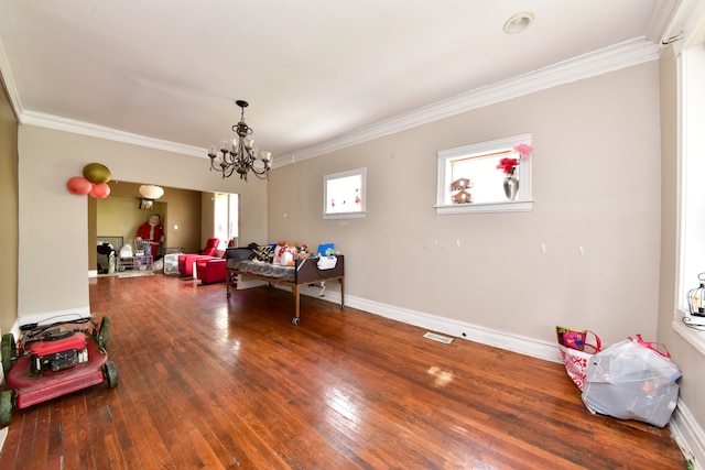 interior space featuring a notable chandelier, crown molding, and hardwood / wood-style flooring