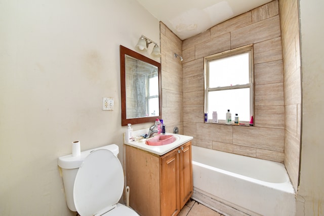 full bathroom with vanity, tile floors, toilet, and tiled shower / bath