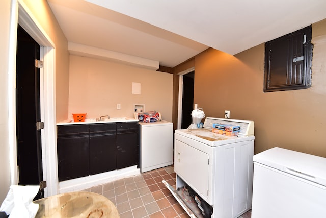 laundry area with independent washer and dryer and light tile floors