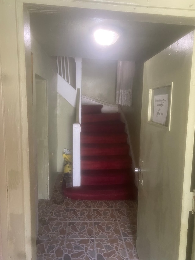 stairway with dark tile flooring