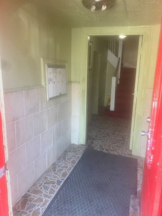 hallway with dark tile floors