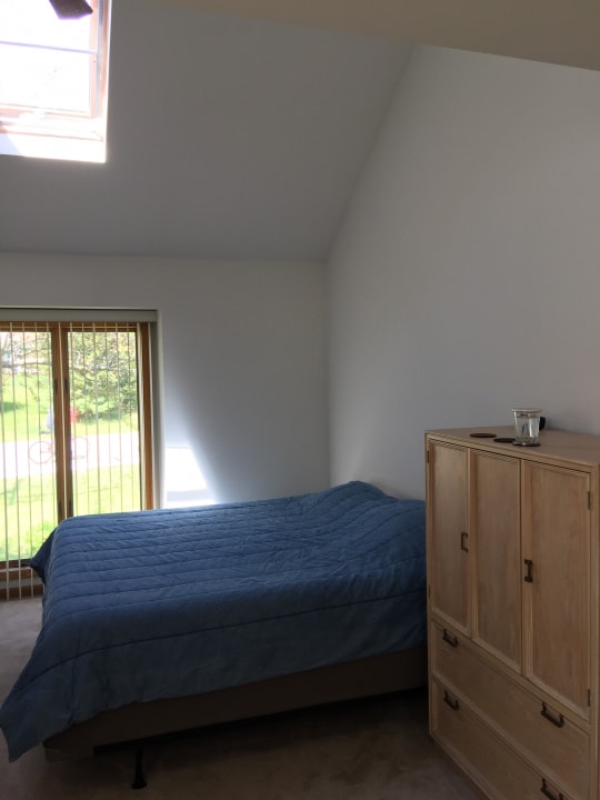 carpeted bedroom featuring lofted ceiling