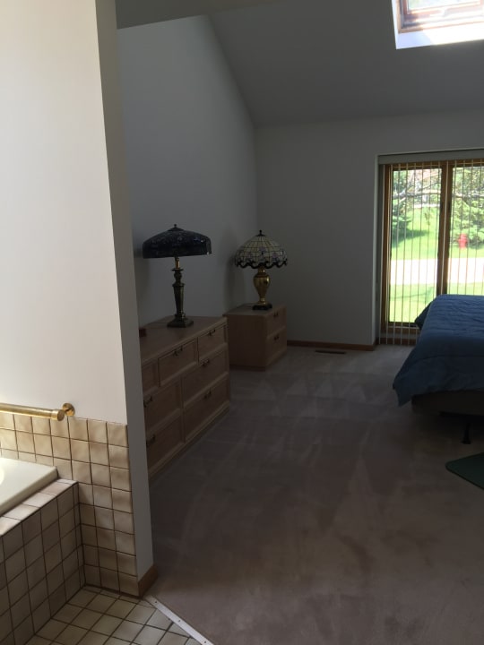 carpeted bedroom with lofted ceiling with skylight