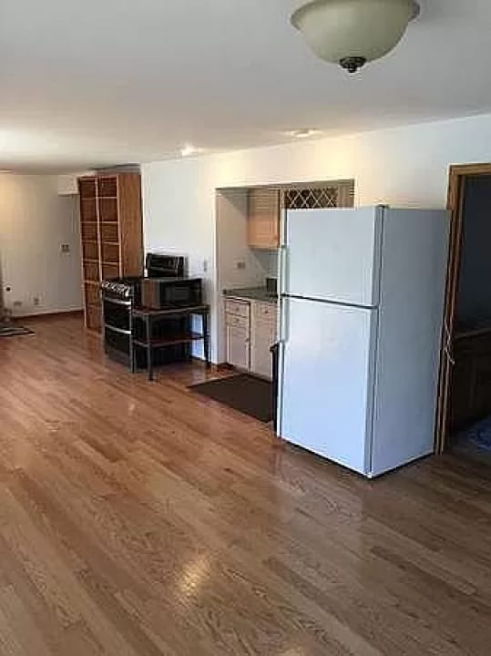 kitchen featuring white fridge and dark hardwood / wood-style floors