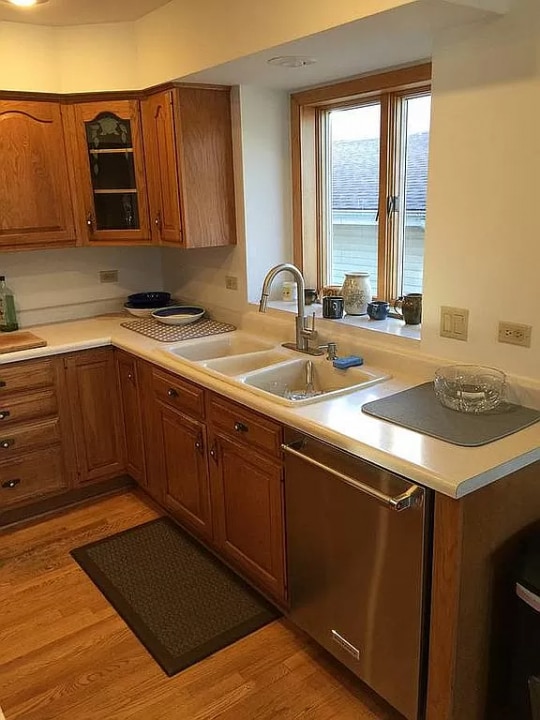 kitchen with dishwasher, light hardwood / wood-style floors, and sink