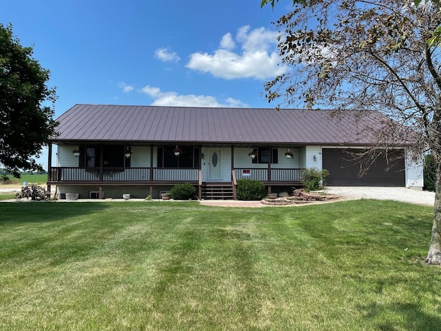 ranch-style home with metal roof, a porch, an attached garage, a standing seam roof, and a front yard