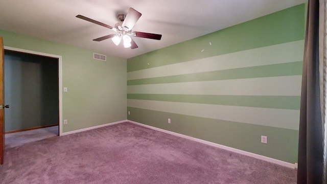 empty room with visible vents, ceiling fan, light carpet, and baseboards