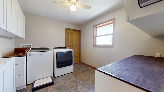 washroom with ceiling fan, baseboards, washer and dryer, cabinet space, and stone finish flooring