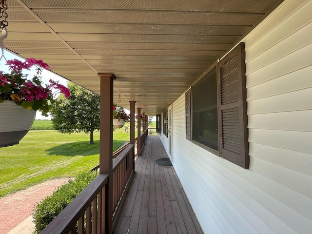 deck with covered porch and a lawn