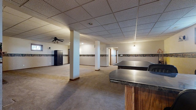 interior space featuring carpet floors and a paneled ceiling