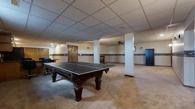 rec room featuring a paneled ceiling and baseboards