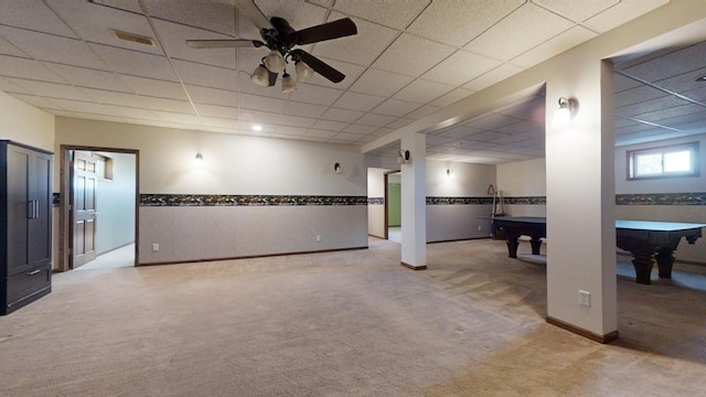 basement with a paneled ceiling, baseboards, visible vents, and carpet flooring