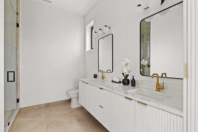 bathroom with toilet, a shower with door, vanity, and tile patterned flooring