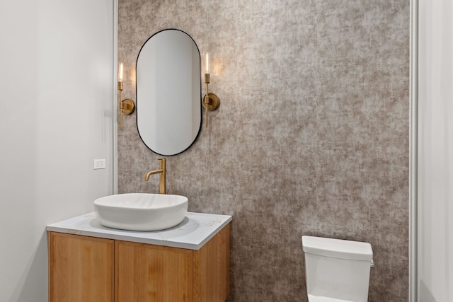 bathroom featuring vanity and toilet