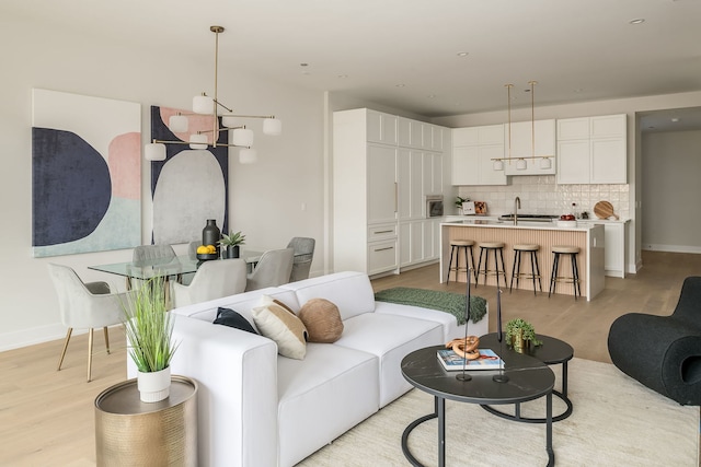 living room with sink and light hardwood / wood-style flooring