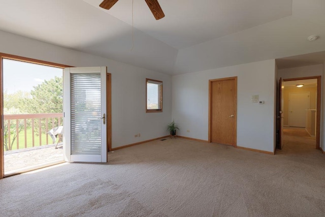 unfurnished room featuring a healthy amount of sunlight, ceiling fan, and carpet