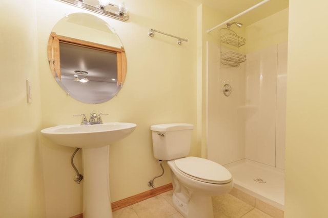 bathroom featuring walk in shower, toilet, and tile flooring